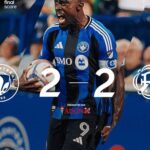 Soccer player in a blue and black kit celebrating with a ball as a 2–2 final score graphic is overlaid, with team logos and sponsor text nearby.