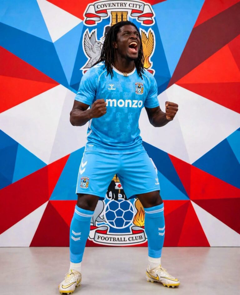 Coventry City footballer in blue kit celebrating with fists clenched in front of a colorful geometric mural and club crest beneath.
