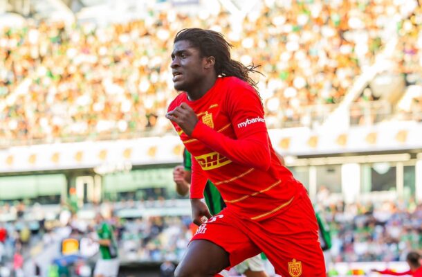 IMG_1589 | Ghanaguardian.com Soccer player sprinting on the field in a red kit with DHL sponsor, crowd blurred in the stands behind.