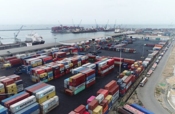 no_translation_11746_e0cy2fufqun7bgm01pwyz9lm_no_translation_translation | Ghanaguardian.com Aerial view of a busy shipping port with colorful stacked shipping containers, cranes, and ships docked at the harbor.