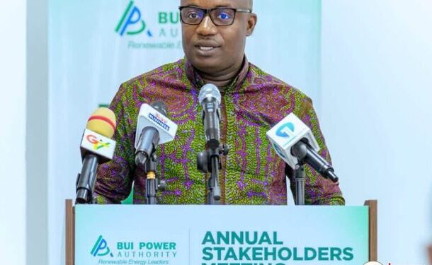 no_translation_11921_e0cy2fufqun7bgm01pwyz9lm_no_translation_translation | Ghanaguardian.com Man in a patterned shirt speaks at a podium with multiple microphones during an Annual Stakeholders event for BUI Power Authority (logo backdrop).