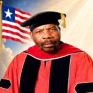 Portrait of a man wearing a red academic gown and mortarboard with an American flag in the background.”